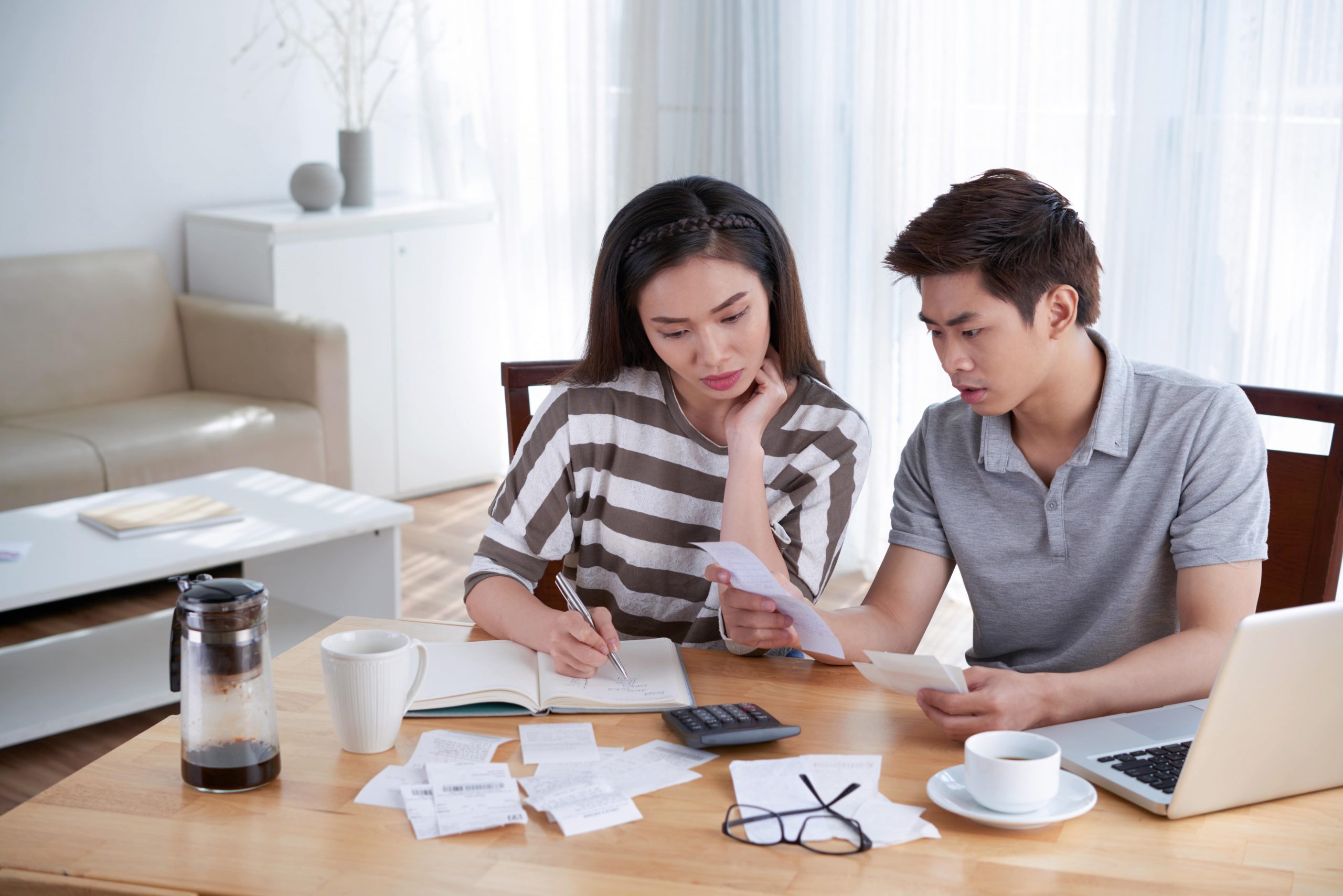 Couple reviewing household finances while planning a home purchase